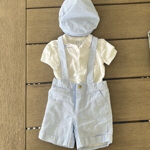 Blue dear sucker overall shorts, matching newsboy hat and white polo.